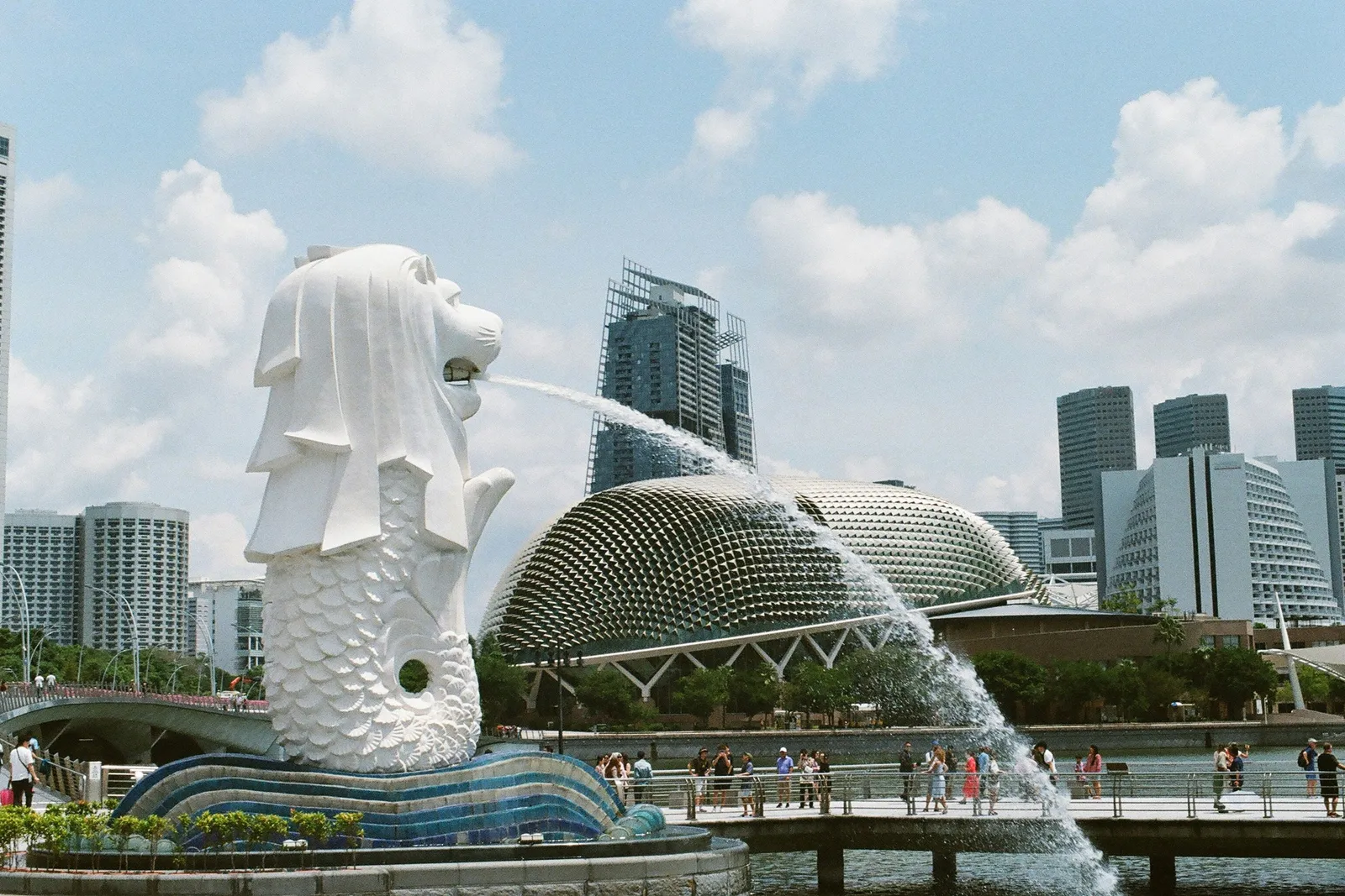 The Merlion fountain at Marina Bay, Singapore, with the Esplanade's domed roofs and the skyline behind it